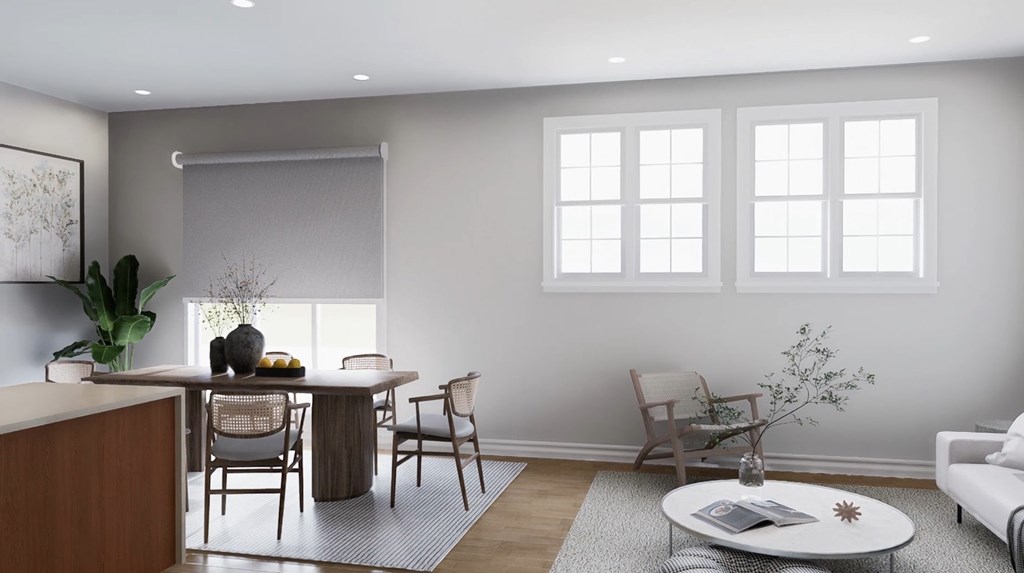 A modern living room with a dining table and chairs.