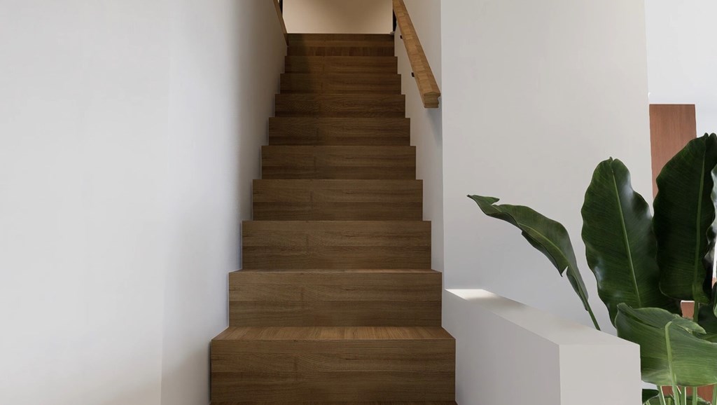 A staircase with wooden steps and a plant on the side.