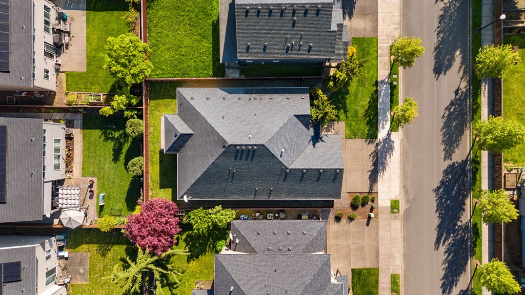 A bird's eye view of a residential area with houses and trees.