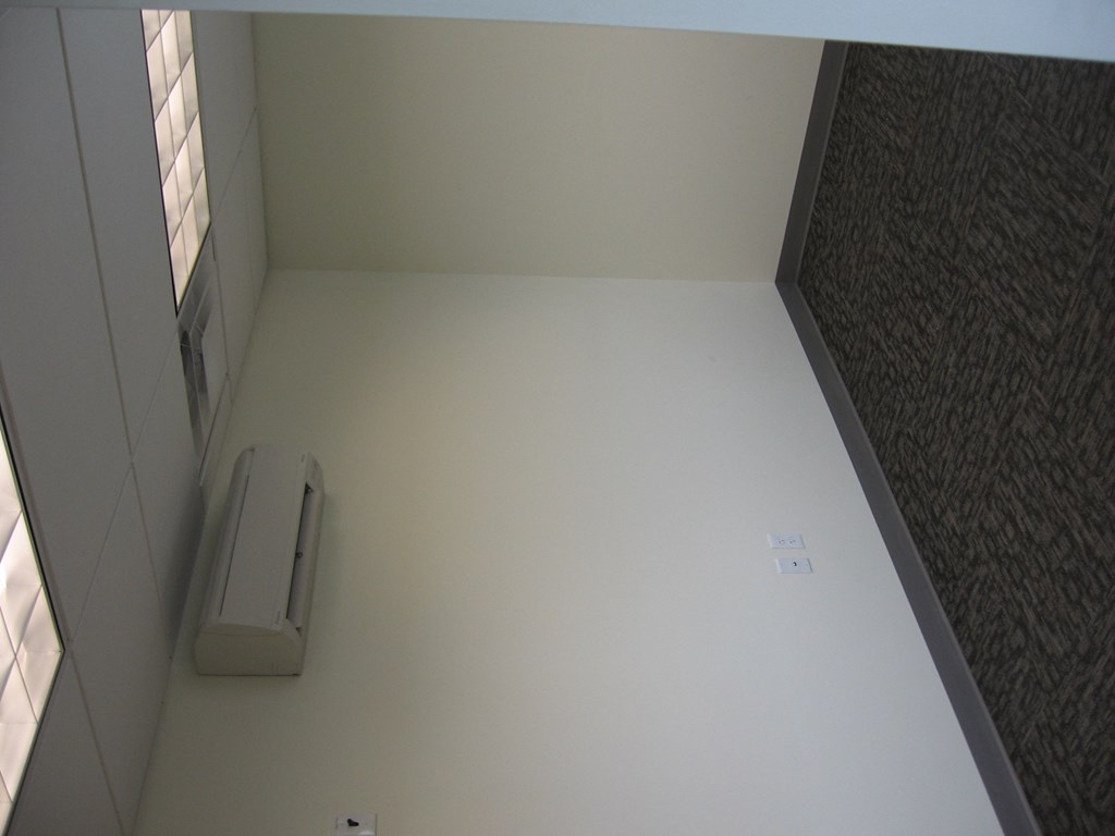 an empty room with a stapler on the floor