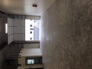 an empty room with a window and a staircase