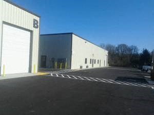 a large white building with a garage door