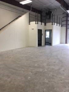 a large empty room with white walls and a door