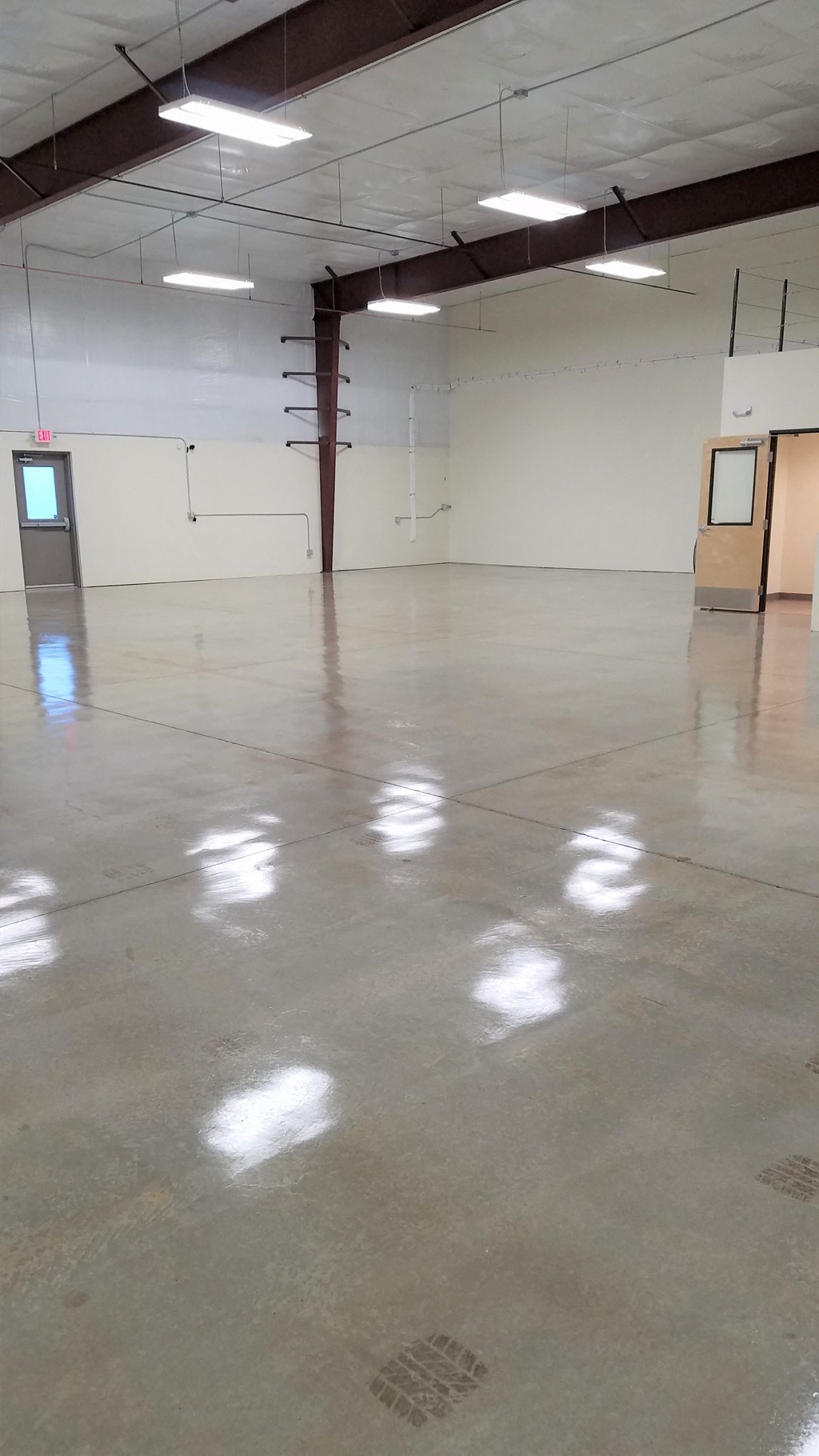 a large warehouse with a concrete floor and white walls