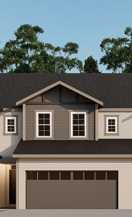 A house with a grey garage door and a brown roof.