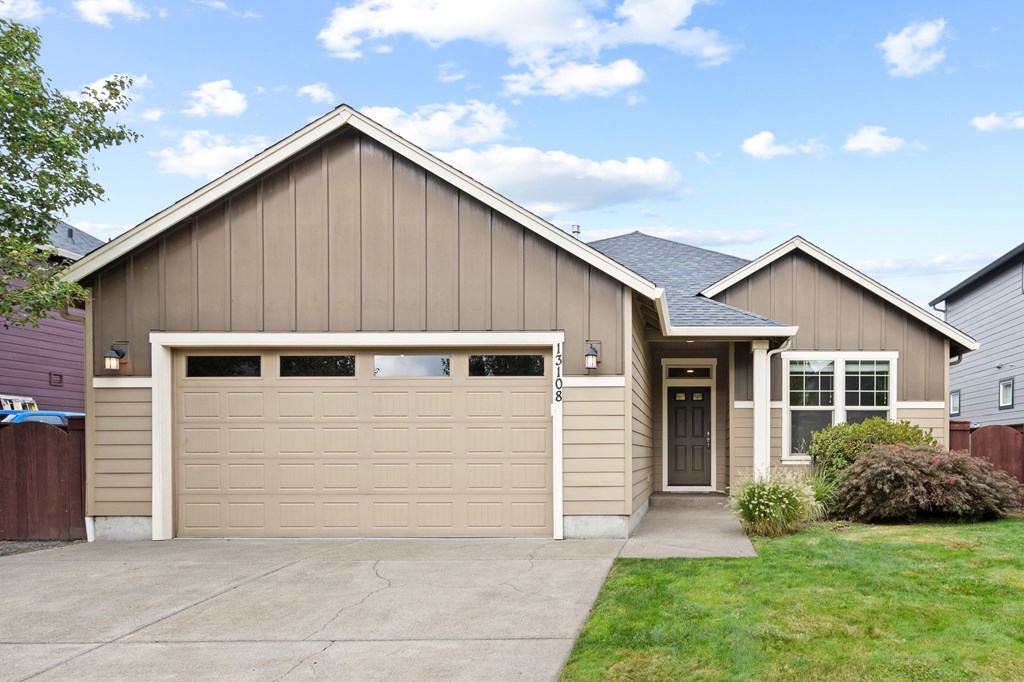 A house with a garage and a driveway.