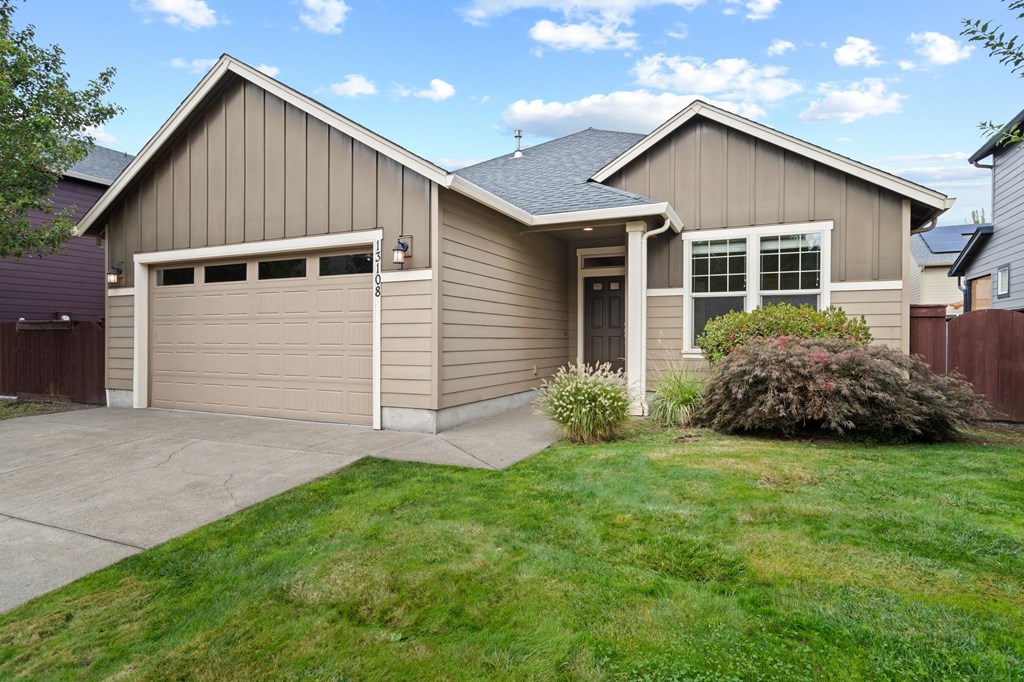 A house with a garage and a driveway.