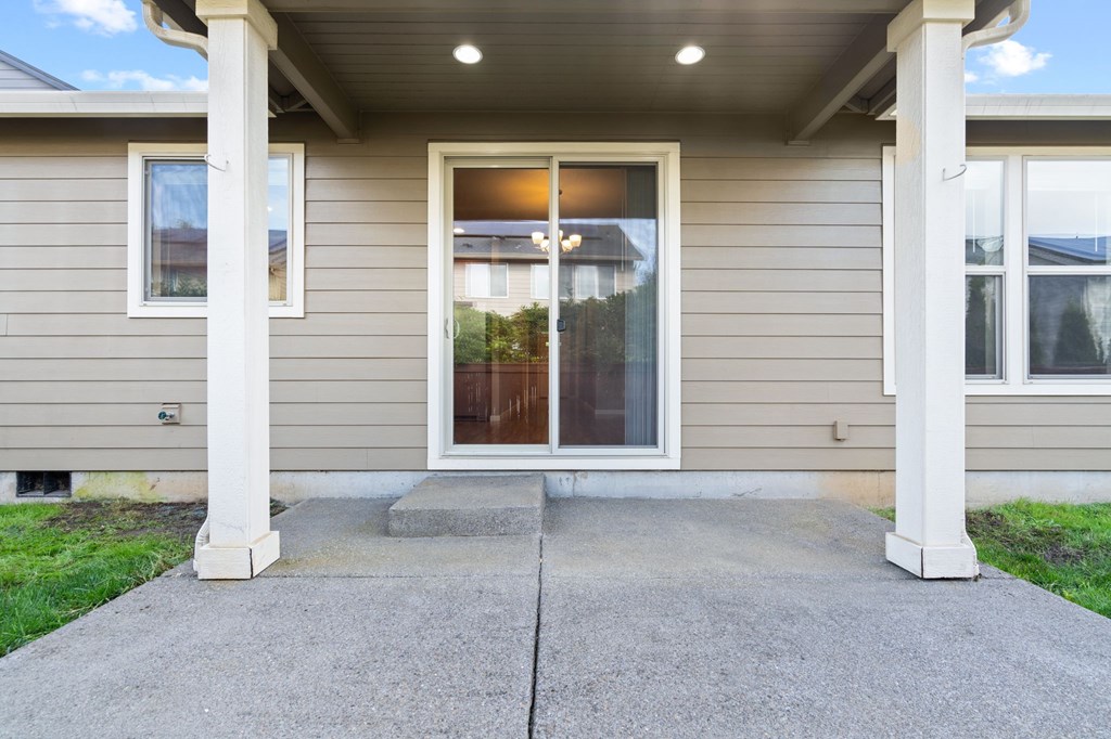 A house with a covered front porch and a brown door.