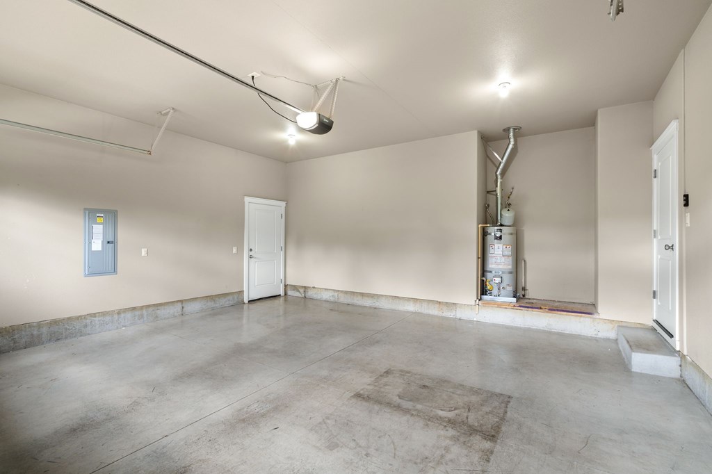 A large empty room with a door on the left and a door on the right.