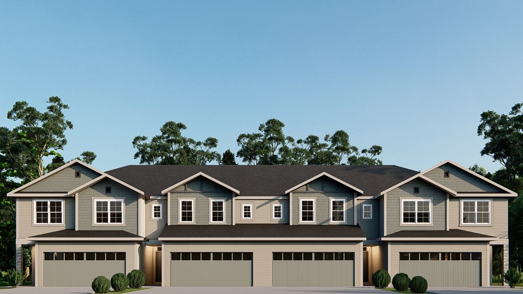 A modern house with a grey roof and multiple garages.