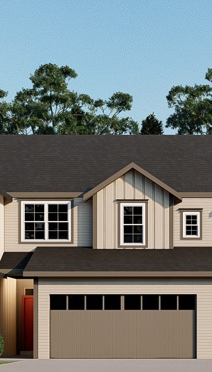 A house with a brown garage door and three windows.