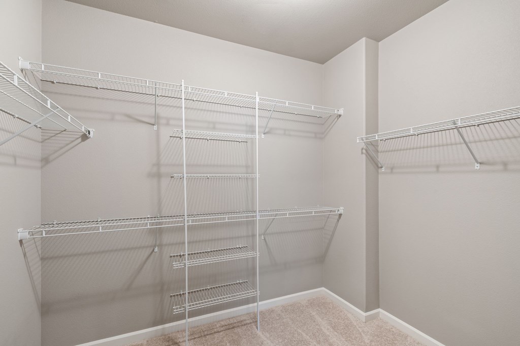 Empty white shelves in a room.