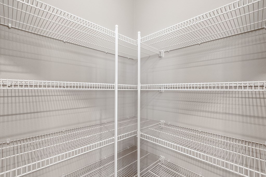 Empty white shelves in a storage room.