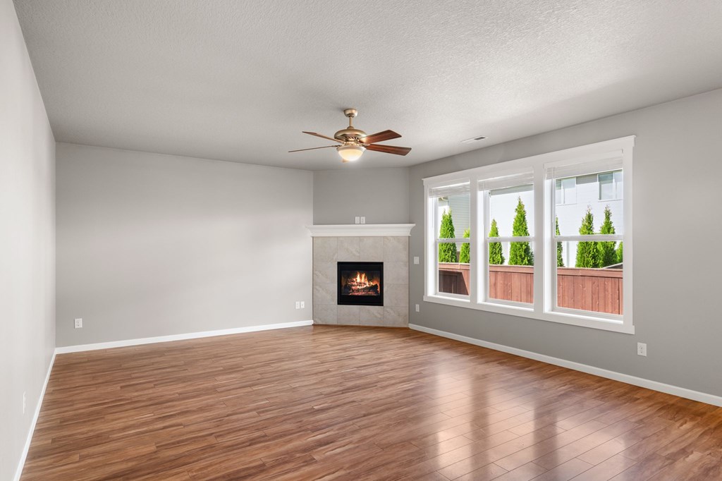 A room with a fireplace and a ceiling fan.