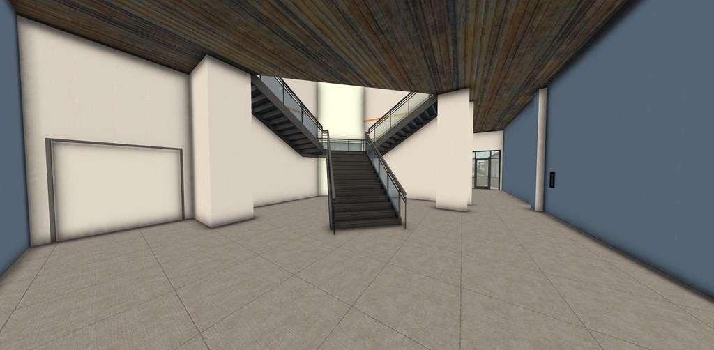 a large empty room with a staircase