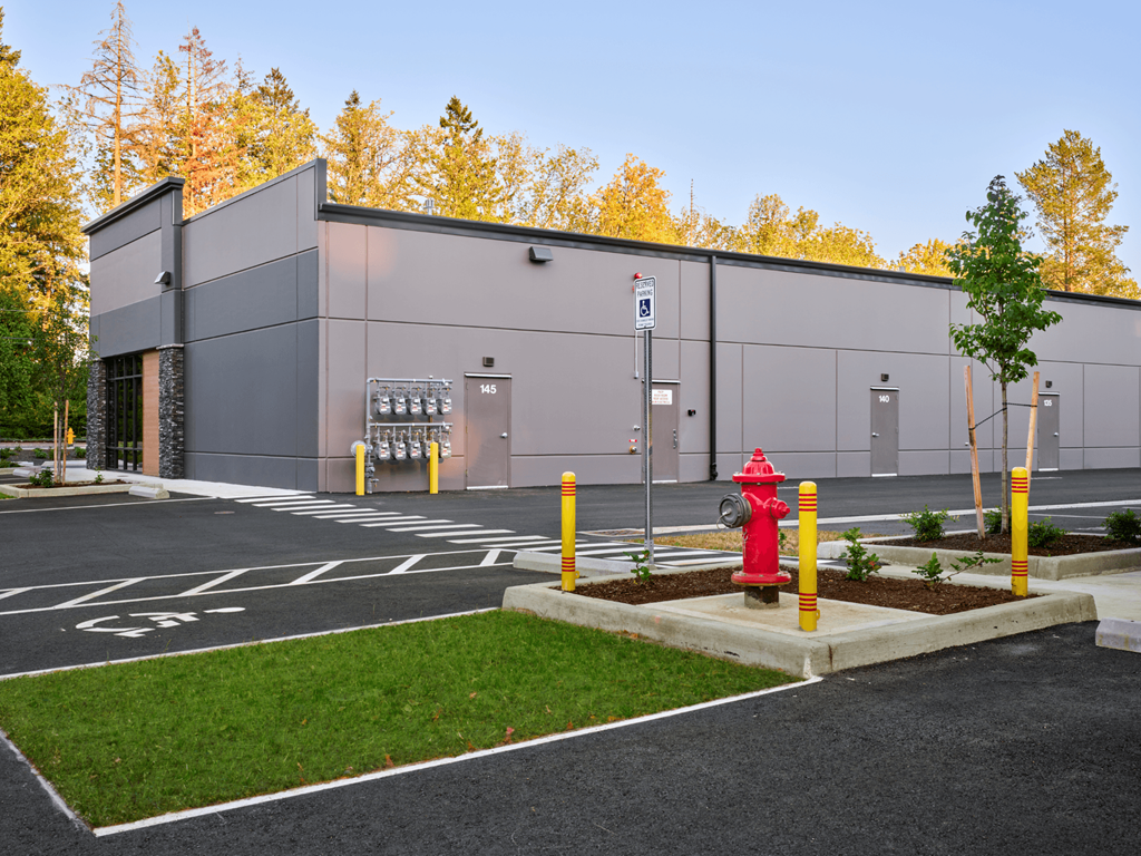 a building with a red fire hydrant in front of it