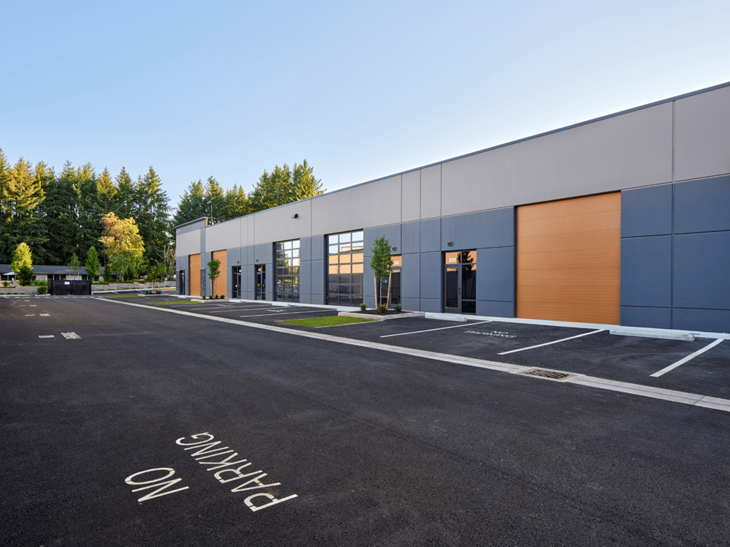 the exterior of a building with a parking lot