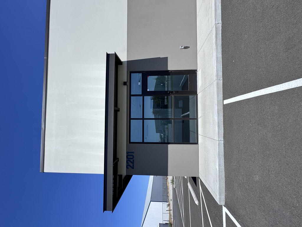 A modern building with a glass door and windows.