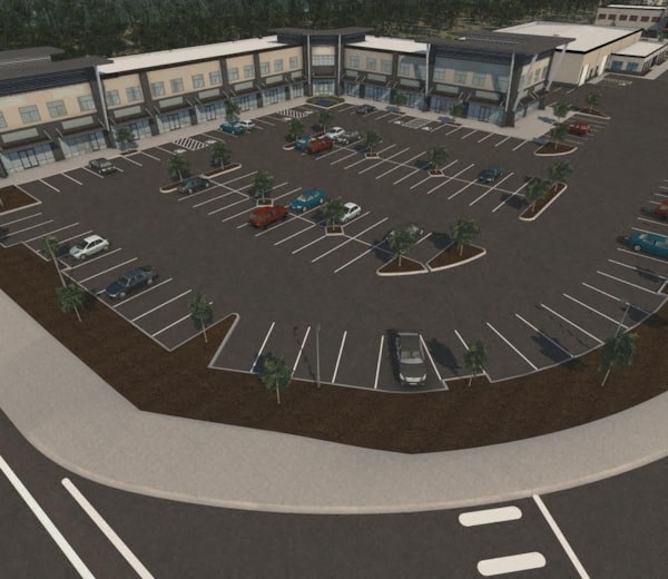 an aerial view of a parking lot with cars and buildings