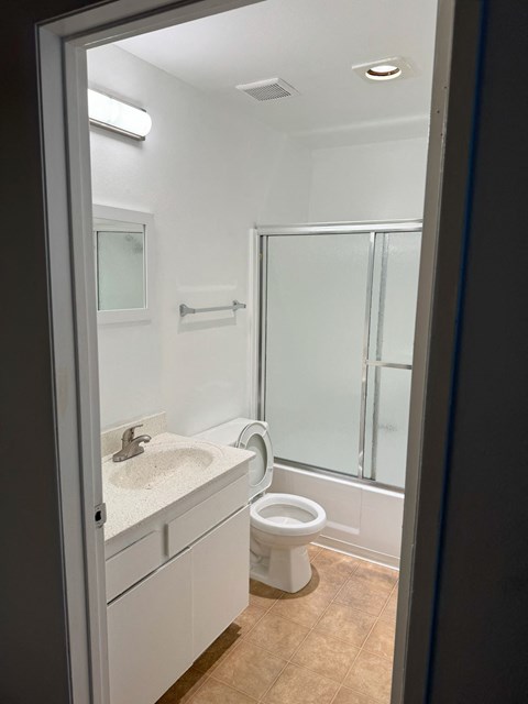 A white sink and toilet in a bathroom.