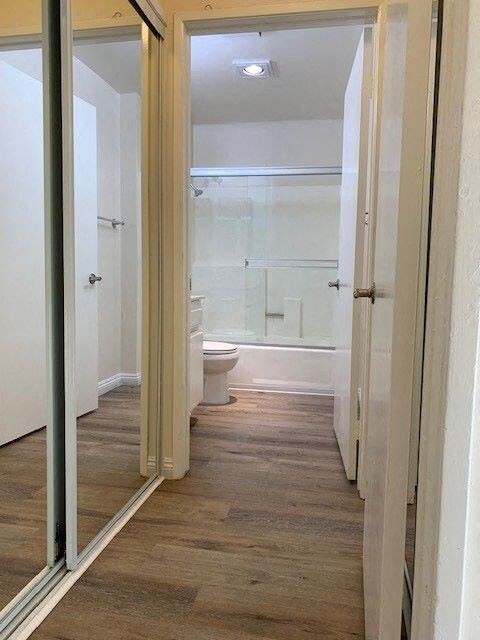 A bathroom with a toilet, sink, and shower.