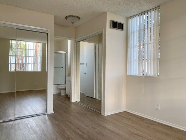 A room with a sliding glass door and a white door.