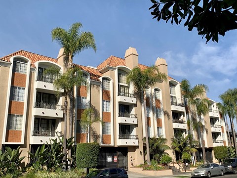 The castle heights apartment building with a red tile roof and balconies.
