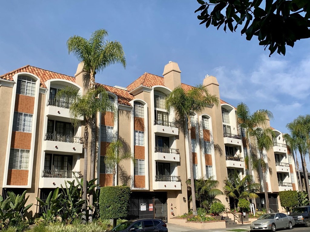 The castle heights apartment building with a red tile roof and balconies.