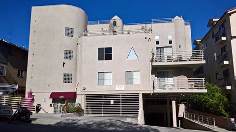 A building with a red awning and a white sign on it.