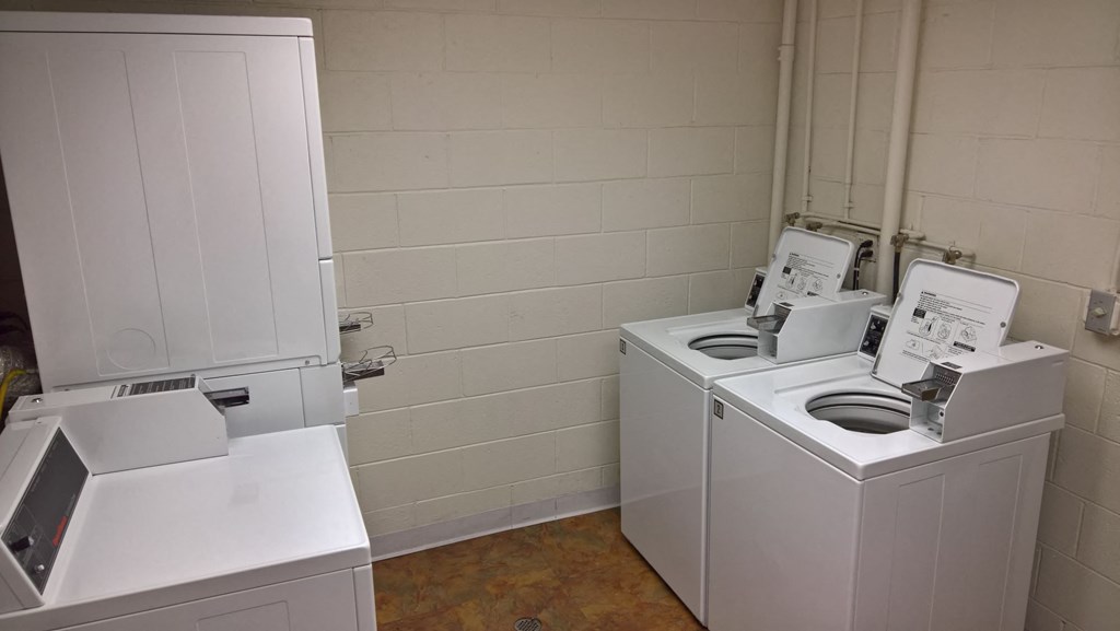 A white washing machine and dryer in a small room.