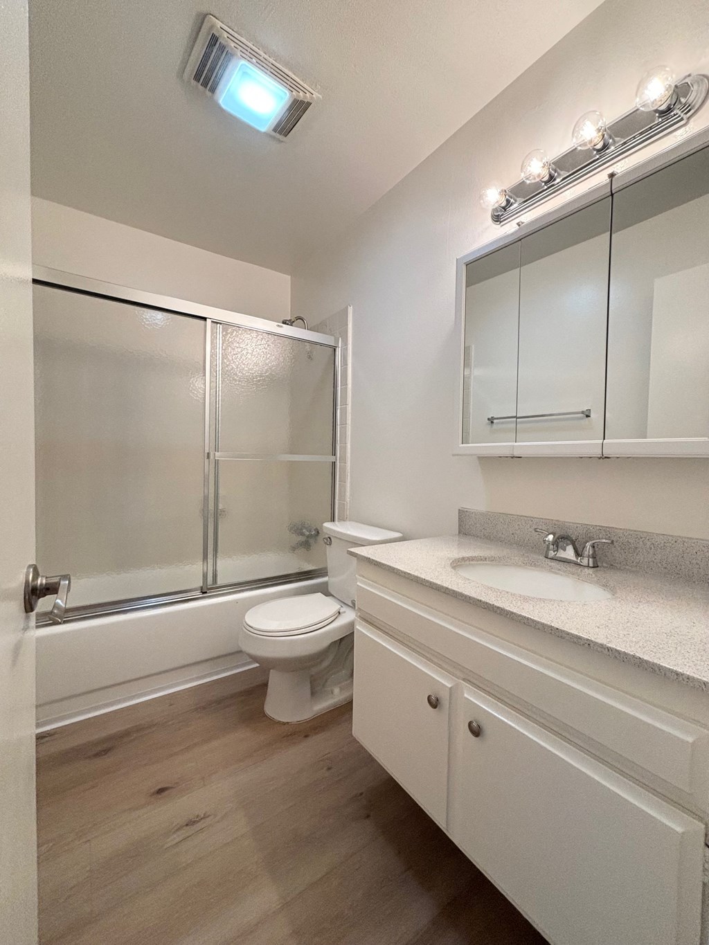 a bathroom with a shower toilet and sink