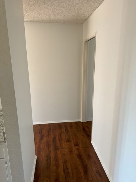 A room with a wooden floor and white walls.