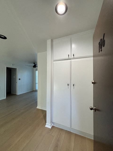 A white cabinet with a black handle is on the wall.