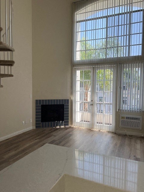 A room with a fireplace and sliding glass doors.