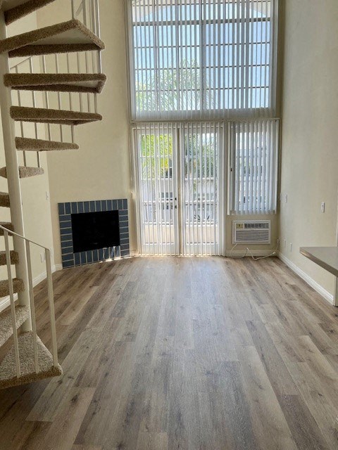 A living room with a fireplace and a staircase.