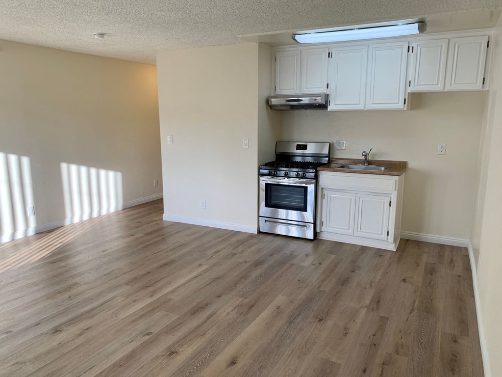 A kitchen with a stove, oven, and cabinets.