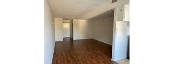 A room with wooden floors and white walls.