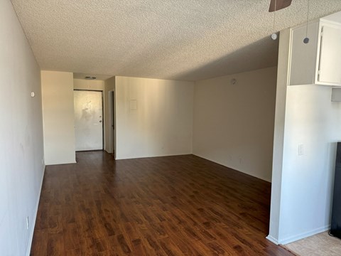 A room with wooden floors and white walls.