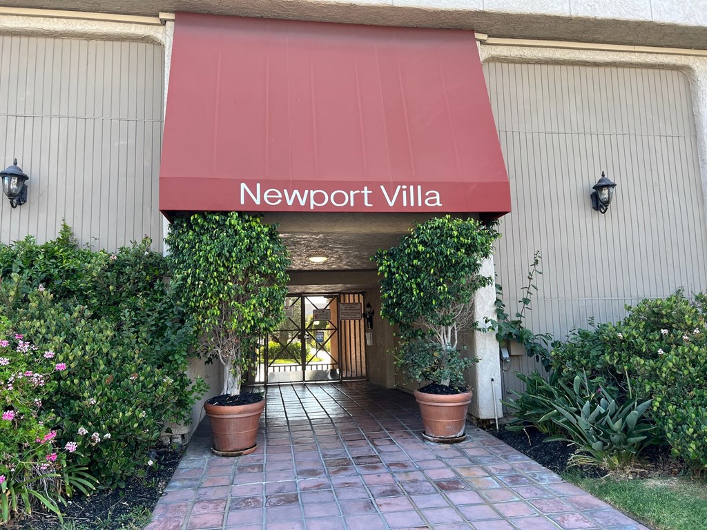 the entrance to the building with a red awning