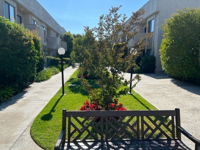 a park bench in the middle of a sidewalk