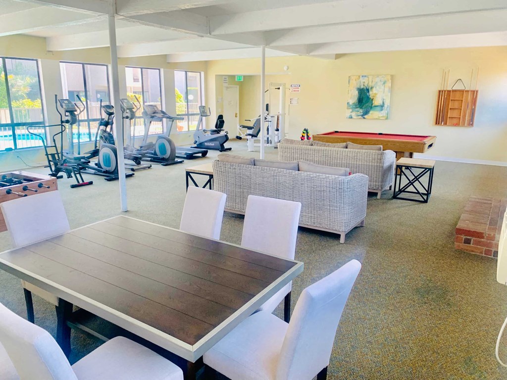 a dining room with a table and chairs and a gym
