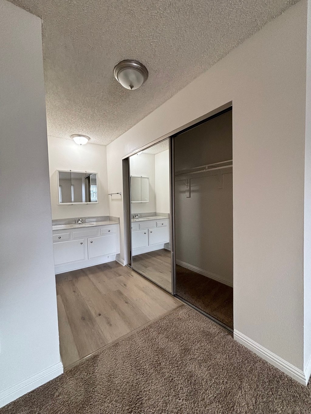 an empty room with a sliding glass door to the laundry room