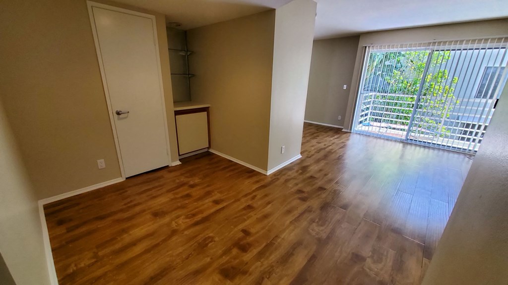 A room with wooden floors and a white door.