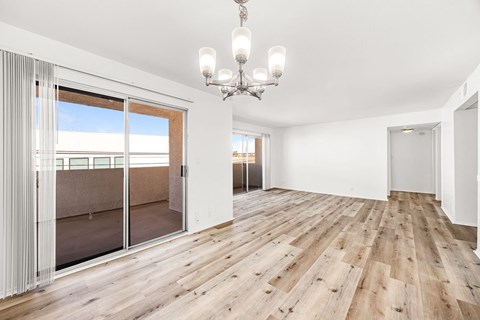 a living room with a sliding glass door and a chandelier