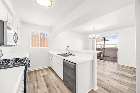 a white kitchen with a stove and a sink