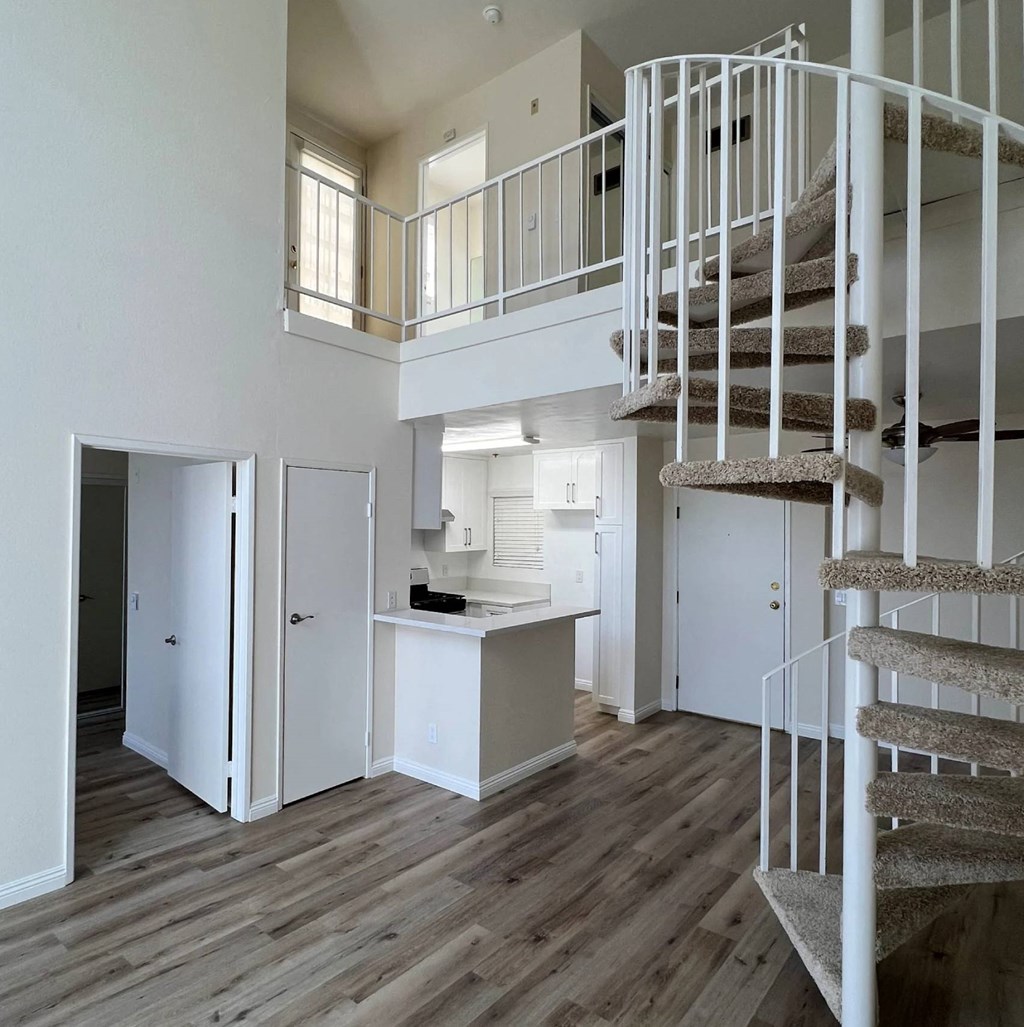 A white interior with a spiral staircase.
