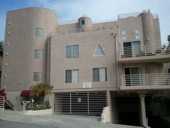 A large building with a balcony on the second floor.