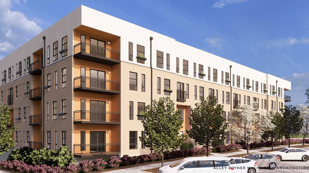 A modern apartment building with balconies and a parking lot in front.