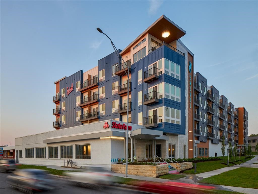 a building with a light on top of it next to a street