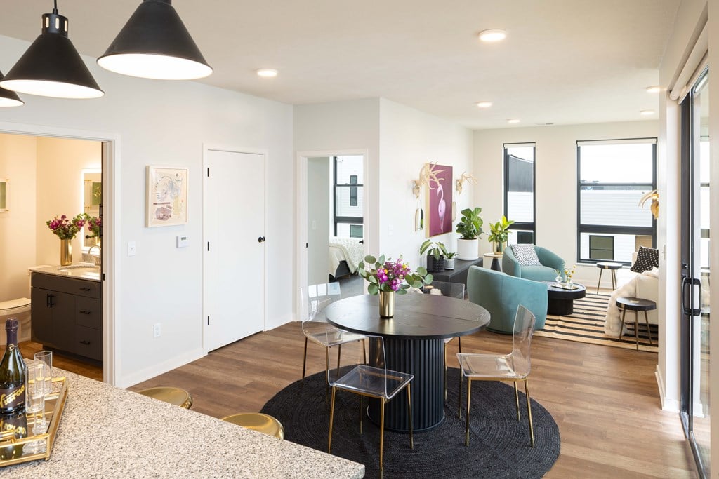 A modern living room with a dining table and chairs.